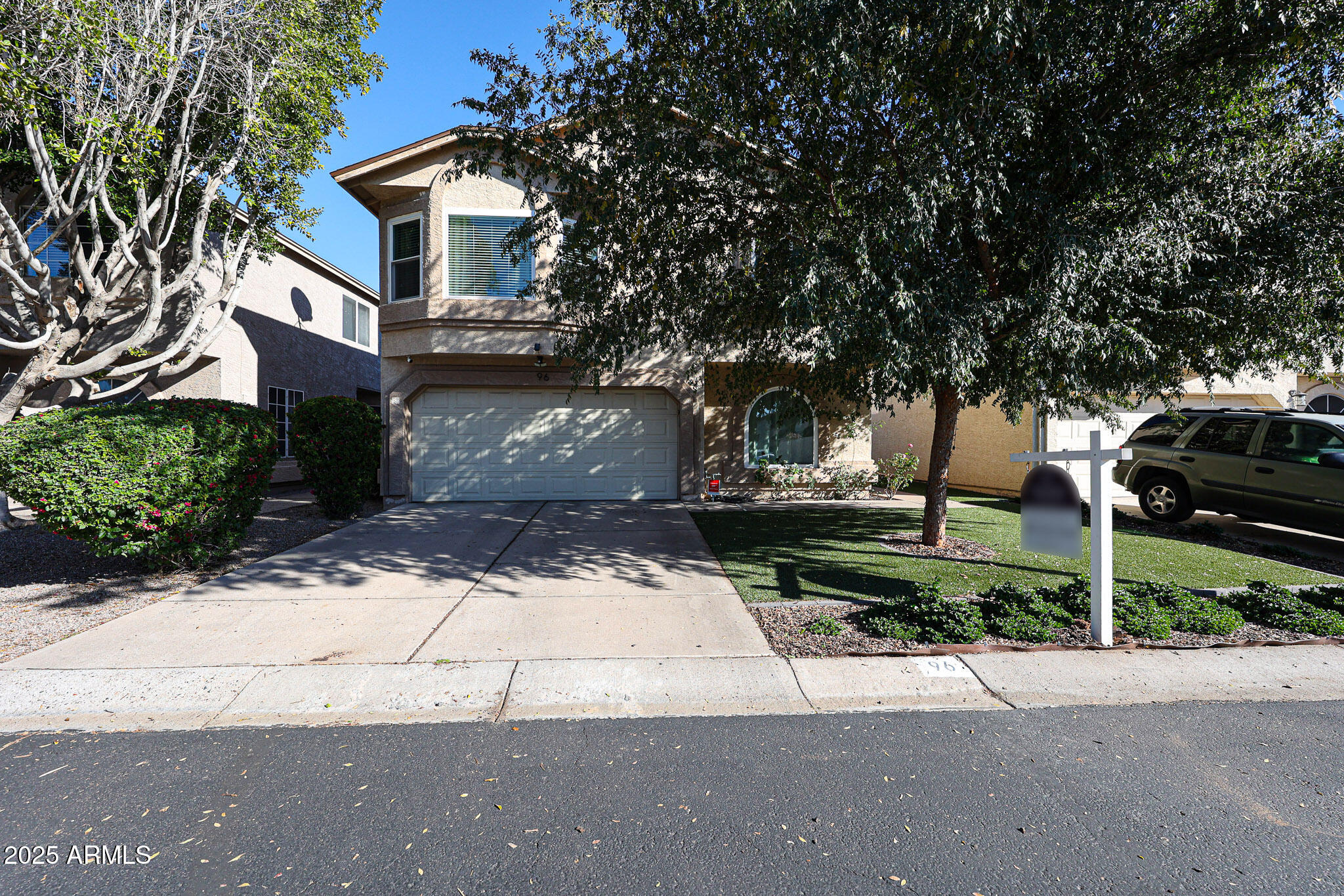 a front view of a house with a yard and a garage