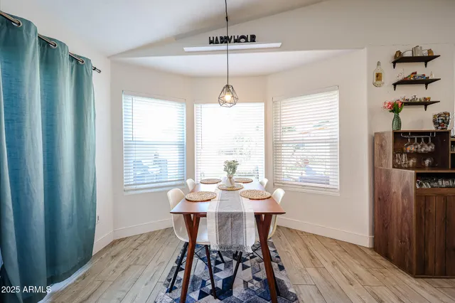 a view of a dining room with furniture window and wooden floor