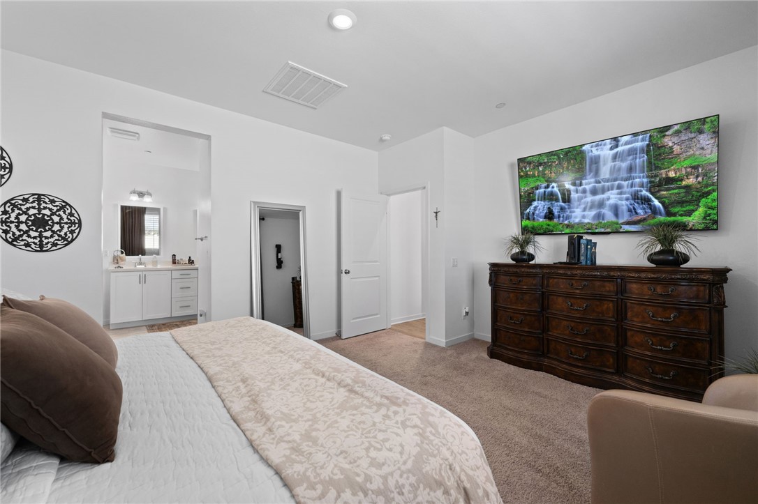 36938 Frantoio Street Beaumont, CA 92223 - Photo 18 of 35 a bedroom with a bed and furniture