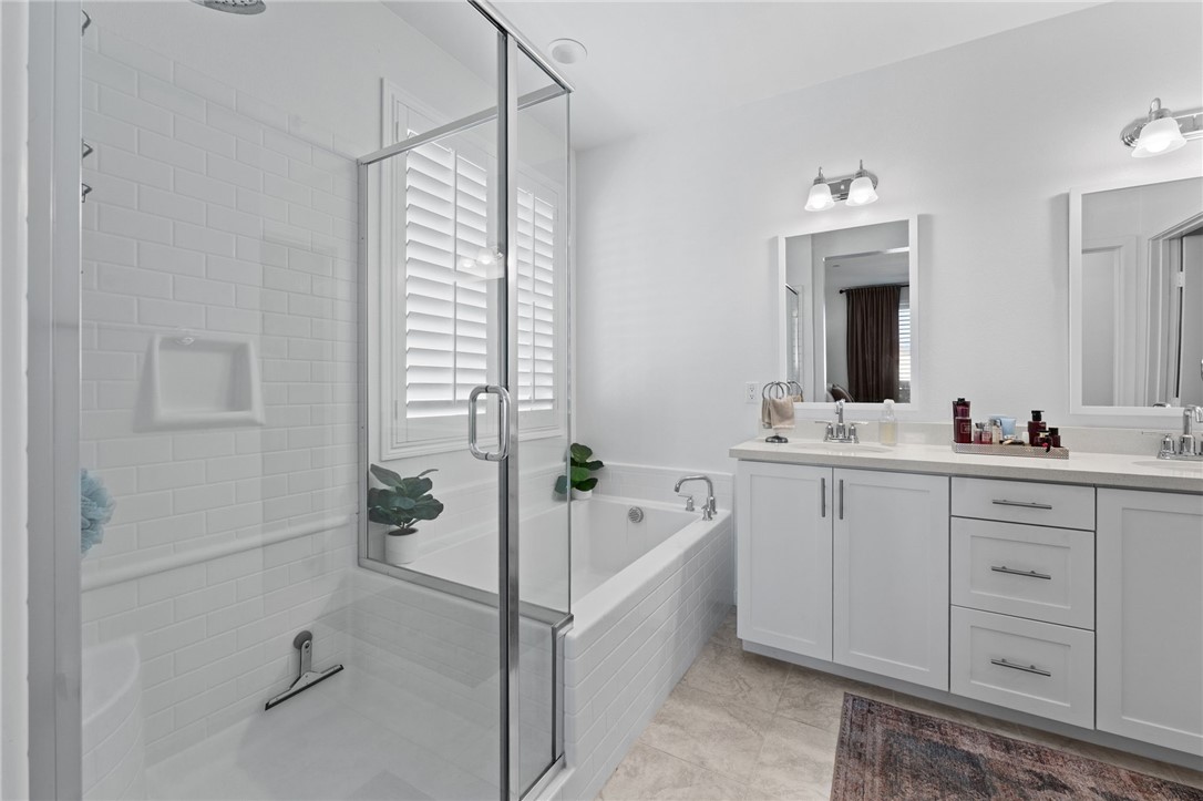 36938 Frantoio Street Beaumont, CA 92223 - Photo 21 of 35 a bathroom with a tub sink and mirror