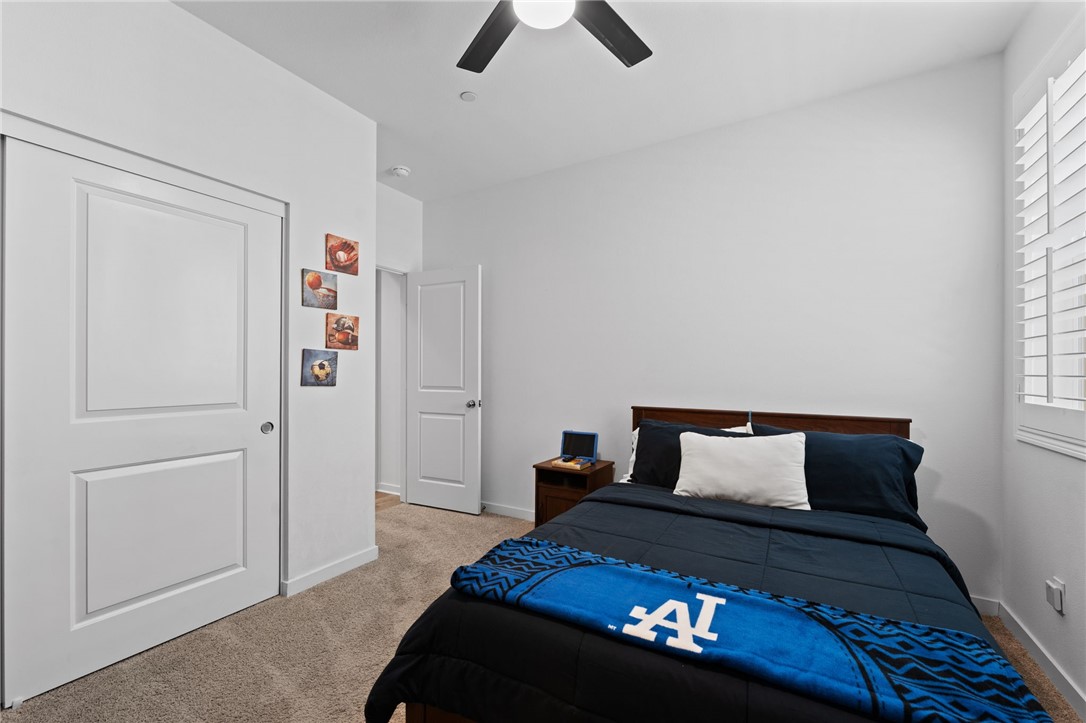 36938 Frantoio Street Beaumont, CA 92223 - Photo 22 of 35 a bedroom with a bed and a lamp on the dresser