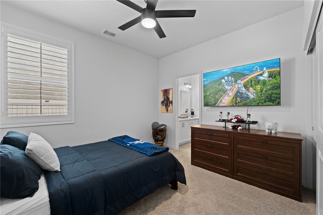 36938 Frantoio Street Beaumont, CA 92223 - Photo 23 of 35 a bedroom with a bed and a flat screen tv