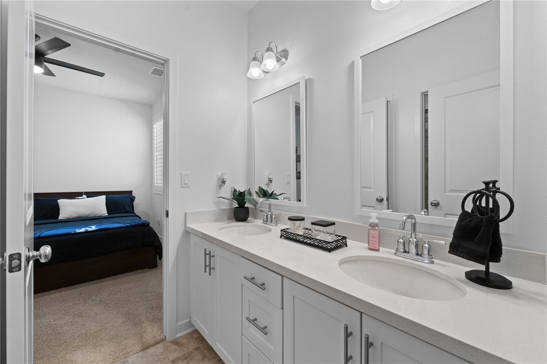 36938 Frantoio Street Beaumont, CA 92223 - Photo 24 of 35 a bathroom with a double vanity sink and a mirror