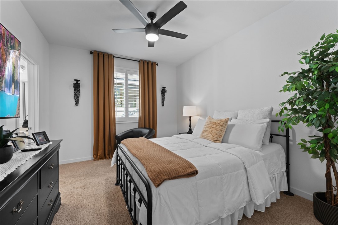 36938 Frantoio Street Beaumont, CA 92223 - Photo 27 of 35 a bedroom with a bed and a chandelier