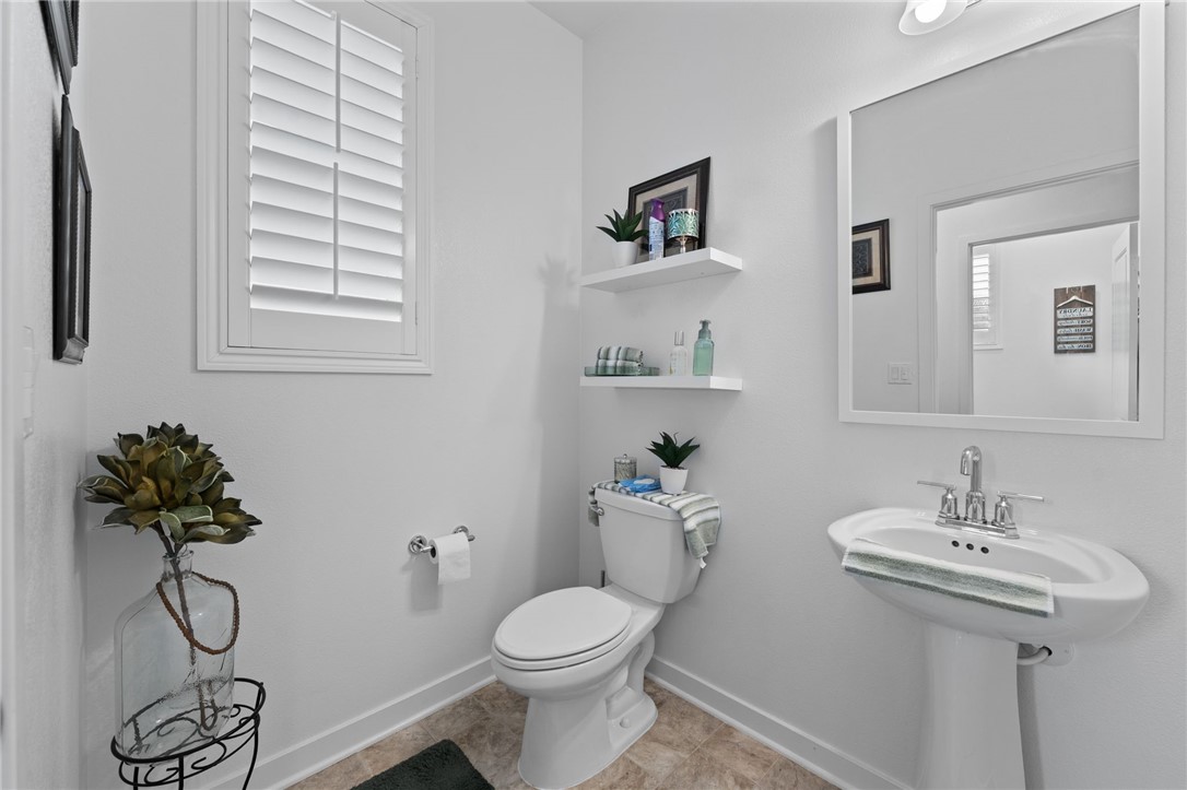 36938 Frantoio Street Beaumont, CA 92223 - Photo 28 of 35 a bathroom with a sink toilet and a mirror