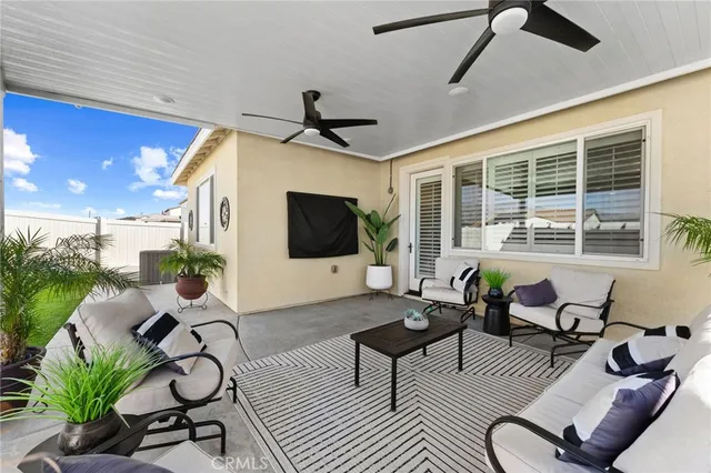 a view of an house with backyard space and a patio