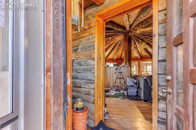 a view of a dining room with furniture a chandelier and a rug