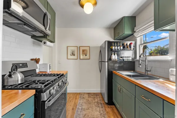 a kitchen with stainless steel appliances granite countertop a stove and a sink