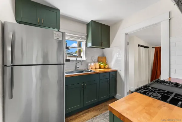 a kitchen with stainless steel appliances granite countertop a refrigerator and a sink