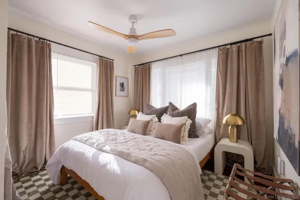 a bedroom with a bed and a window