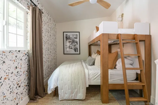 a bedroom with a bed and a wall painting