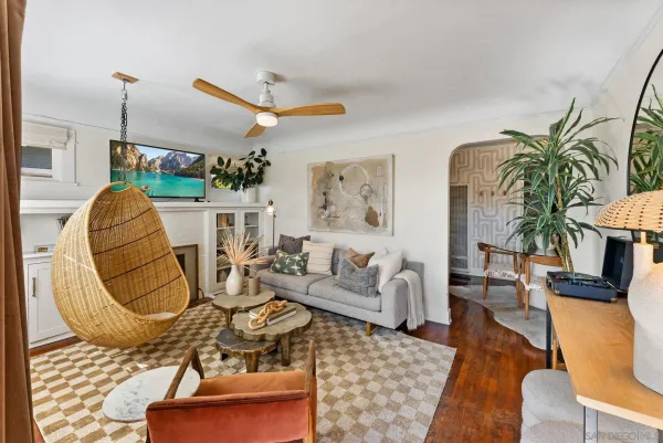 a living room with furniture a rug and white walls