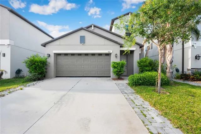 a front view of a house with a yard and garage