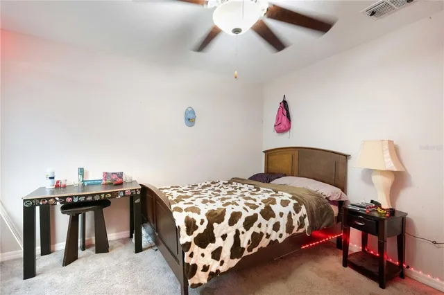 a bedroom with a bed and a lamp