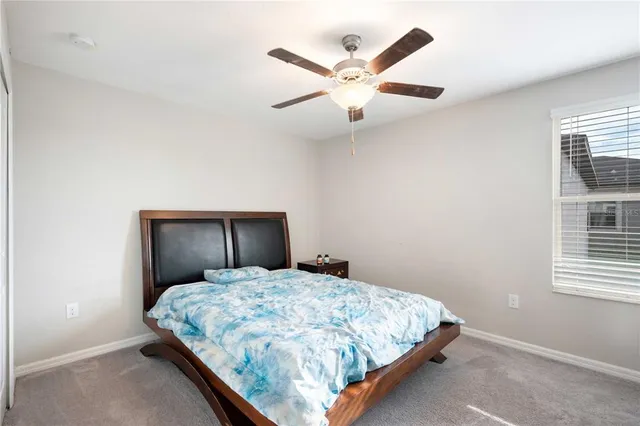 a bedroom with a large bed and a large window