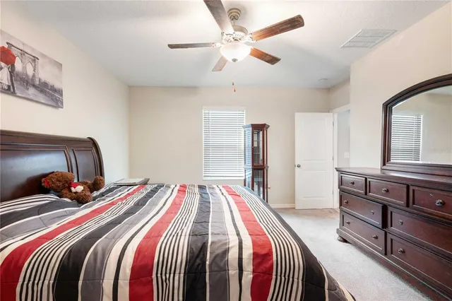 a bed room with a bed and a chandelier
