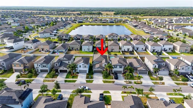 an aerial view of a building with a swimming pool yard and outdoor seating