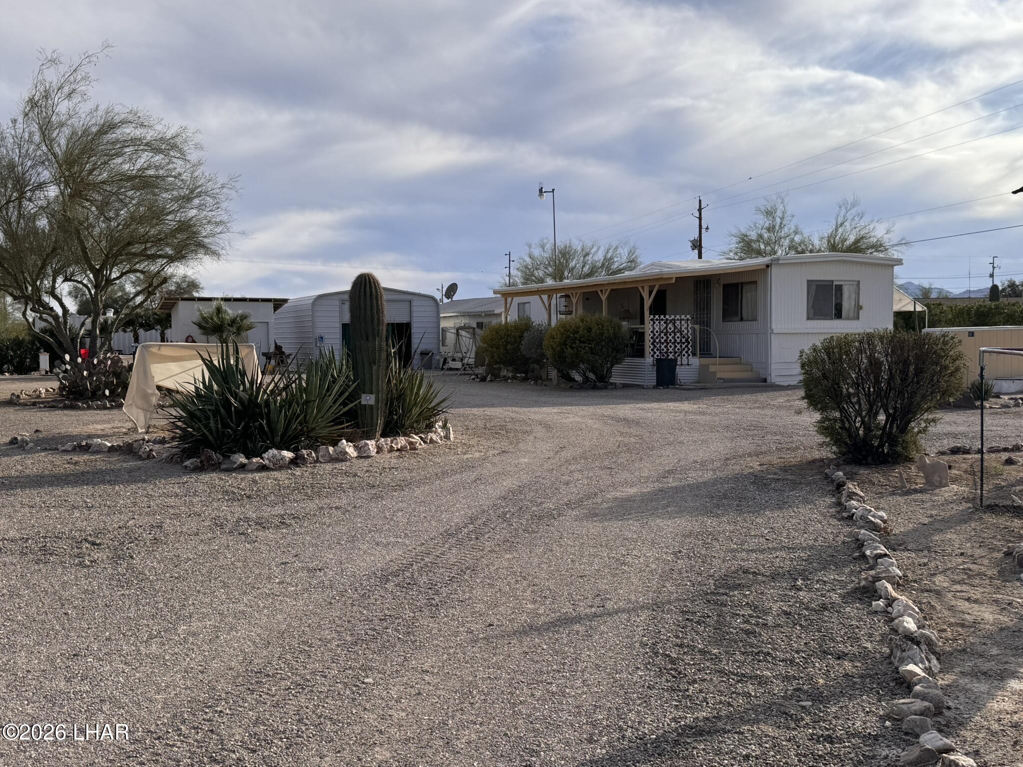 a view of a dry yard with a house