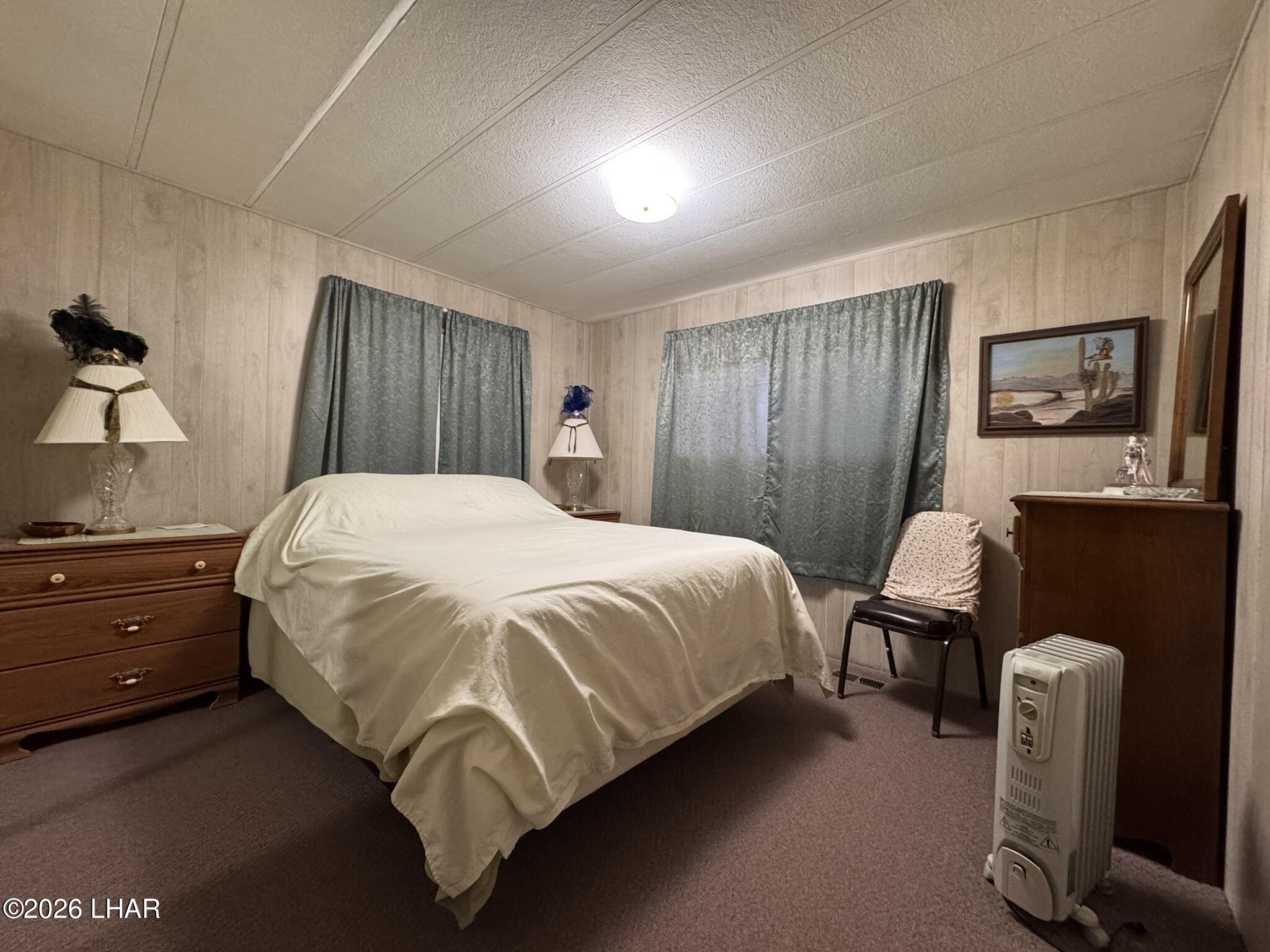 587 West Pyramid Street Quartzsite, AZ 85346 - Photo 12 of 46 a bedroom with a bed and wooden floor