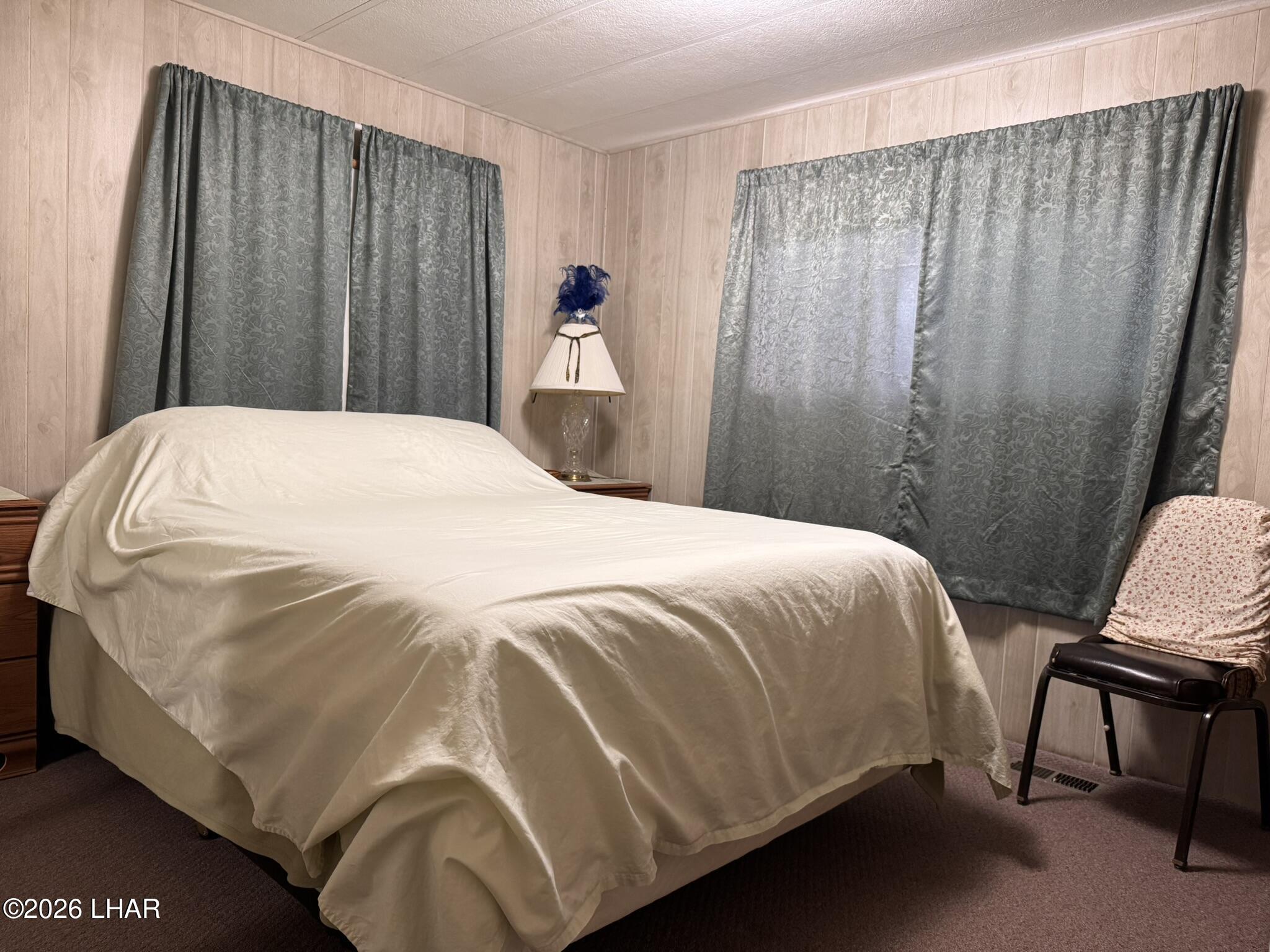 587 West Pyramid Street Quartzsite, AZ 85346 - Photo 13 of 46 a bed sitting in a bedroom next to a wooden door