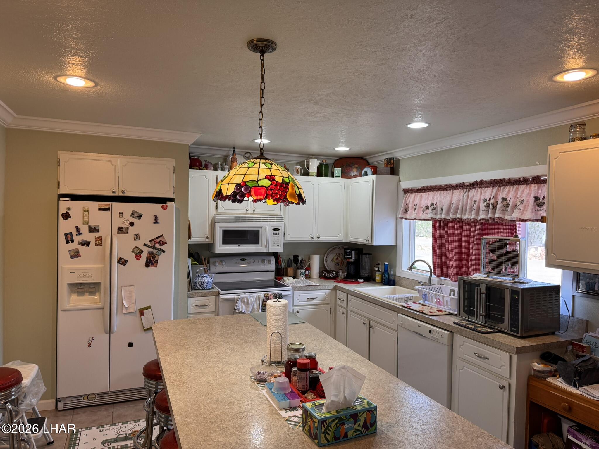 587 West Pyramid Street Quartzsite, AZ 85346 - Photo 23 of 46 a kitchen with granite countertop a sink appliances and cabinets