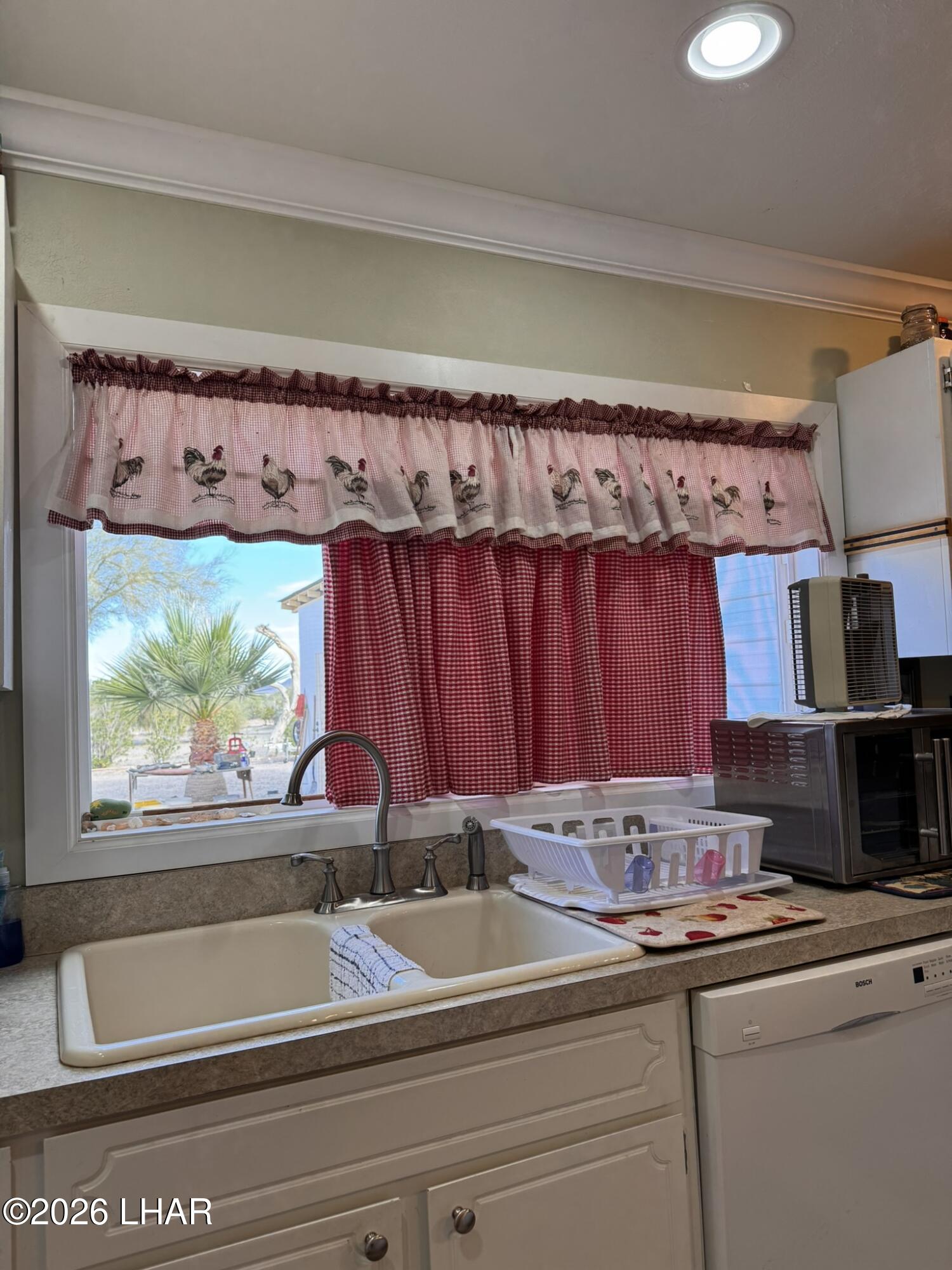 587 West Pyramid Street Quartzsite, AZ 85346 - Photo 32 of 46 a kitchen with a sink and a window