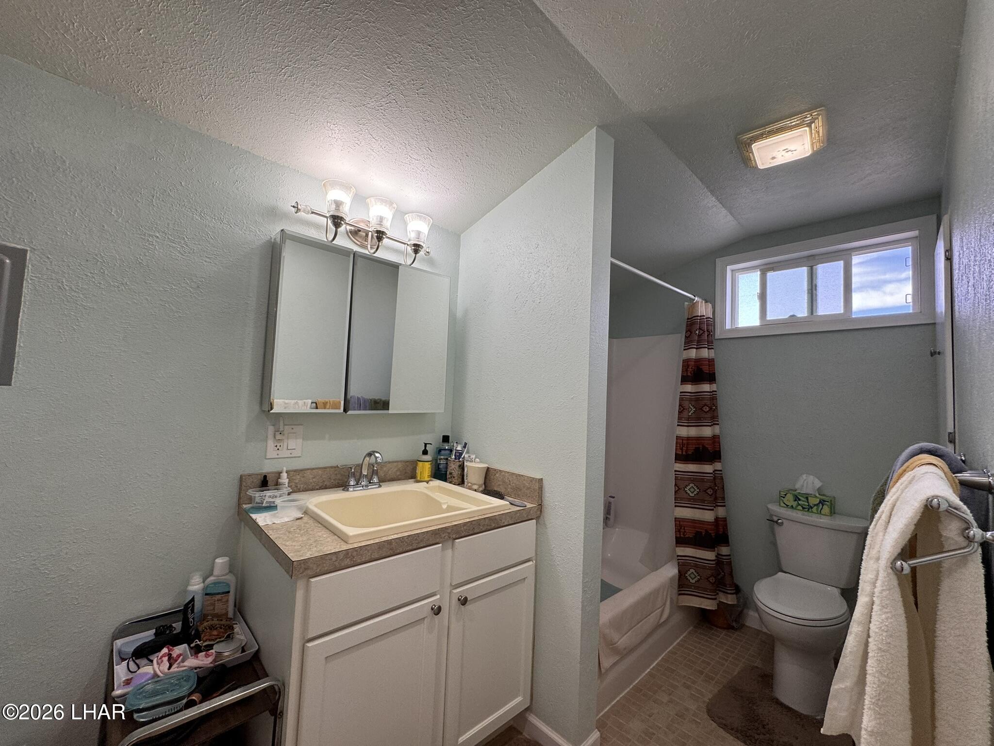 587 West Pyramid Street Quartzsite, AZ 85346 - Photo 34 of 46 a bathroom with a sink toilet vanity and window