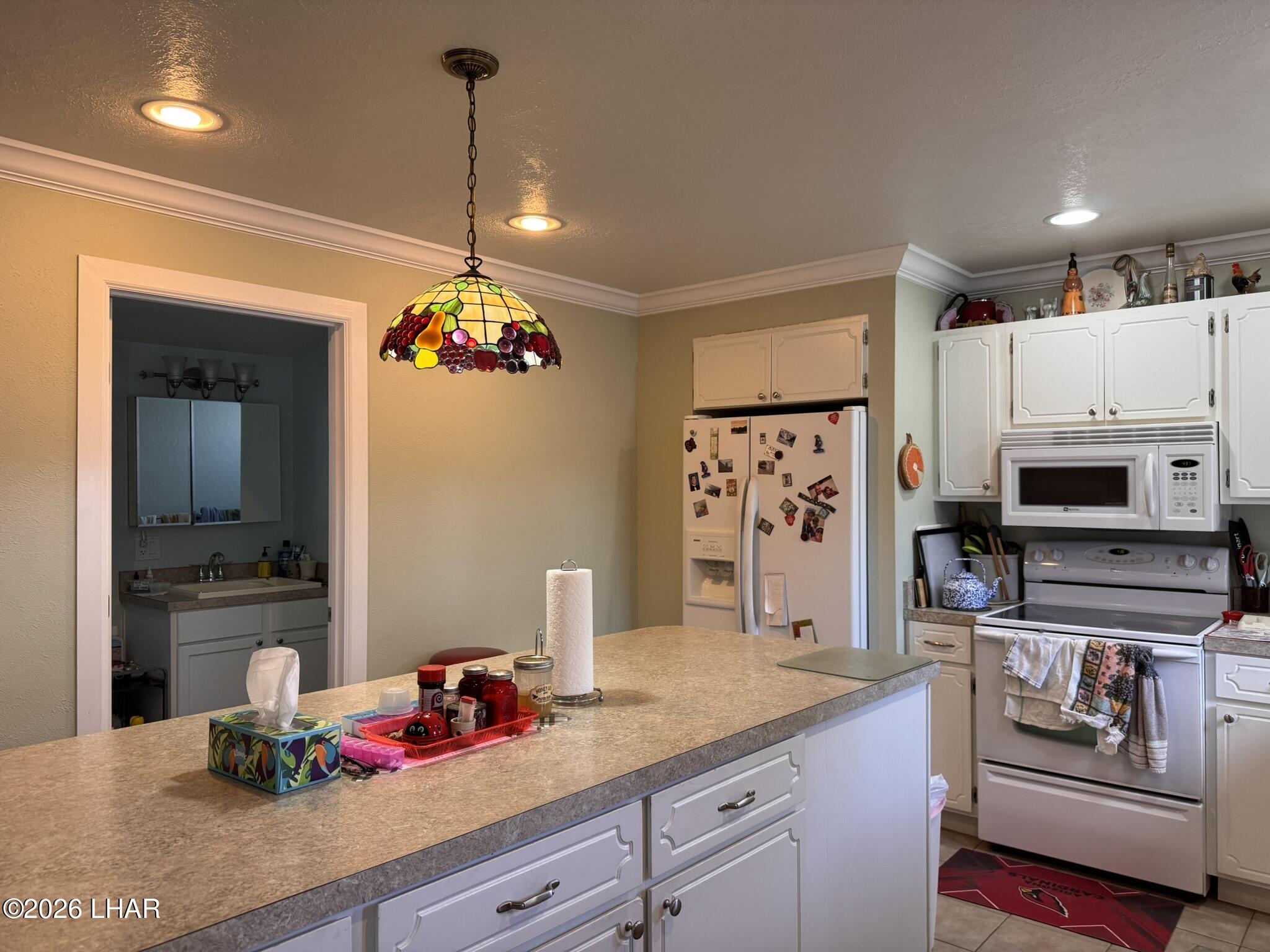 587 West Pyramid Street Quartzsite, AZ 85346 - Photo 36 of 46 a kitchen with kitchen island granite countertop stainless steel appliances a stove refrigerator and a sink