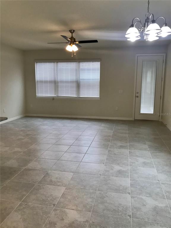 2680 Mead Avenue St. Cloud, FL 34771 - Photo 4 of 35 a view of a livingroom with a chandelier fan and a window