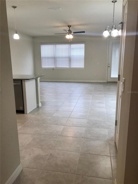 2680 Mead Avenue St. Cloud, FL 34771 - Photo 7 of 35 a view of a livingroom with a chandelier fan and windows