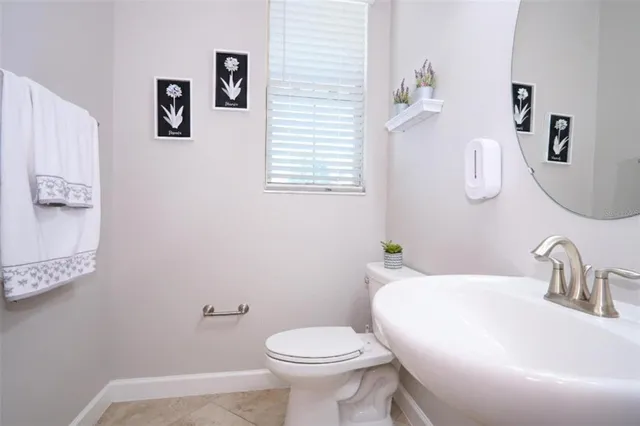 a bathroom with a sink toilet and mirror