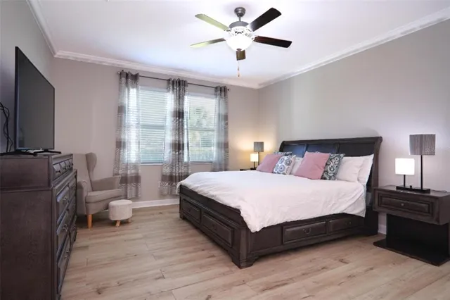 a bedroom with a bed and wooden floor