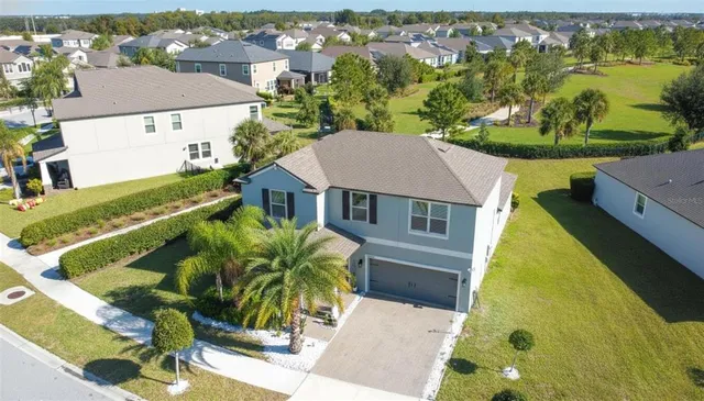 an aerial view of residential houses with outdoor space