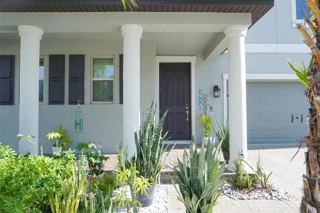a front view of a house with potted plants