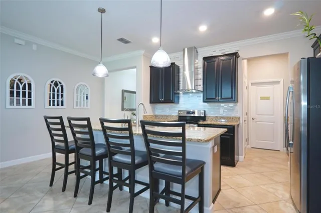 a kitchen with a table chairs refrigerator and microwave