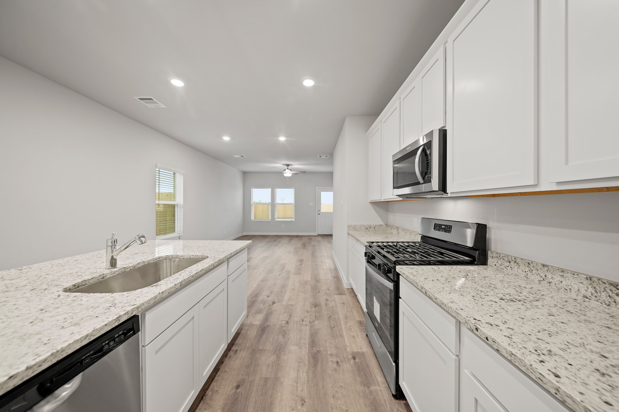 310 Amy Street Angleton, TX 77515 - Photo 18 of 26 a kitchen with granite countertop sink stainless steel appliances and window