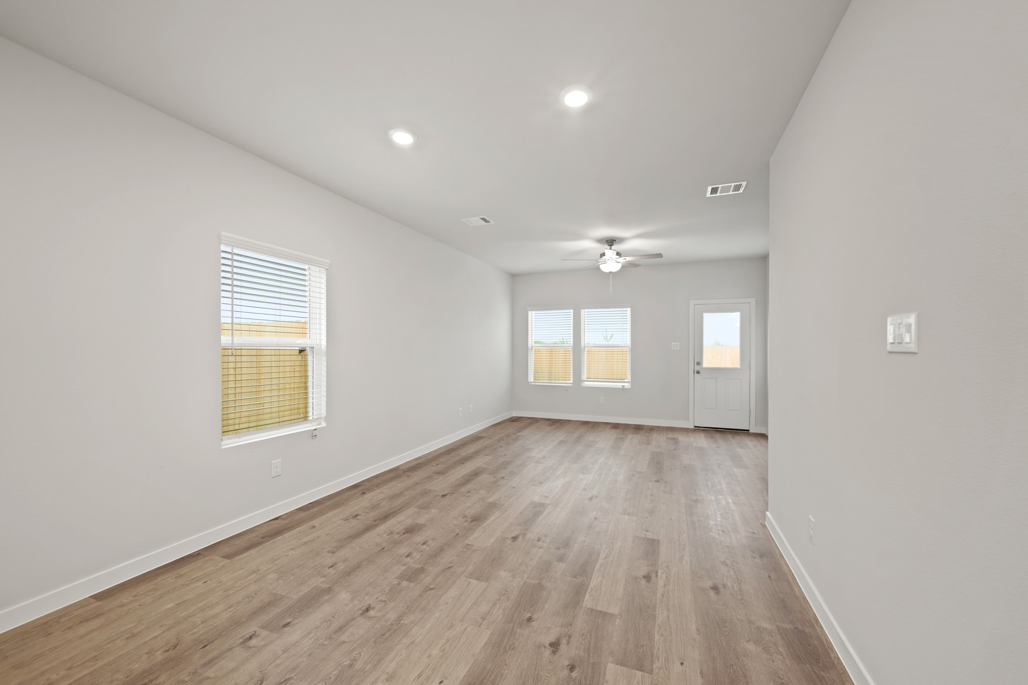 310 Amy Street Angleton, TX 77515 - Photo 7 of 26 wooden floor in an empty room with a window
