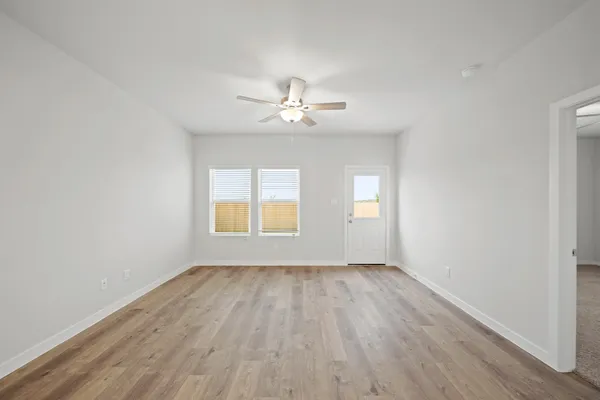wooden floor in an empty room with a window