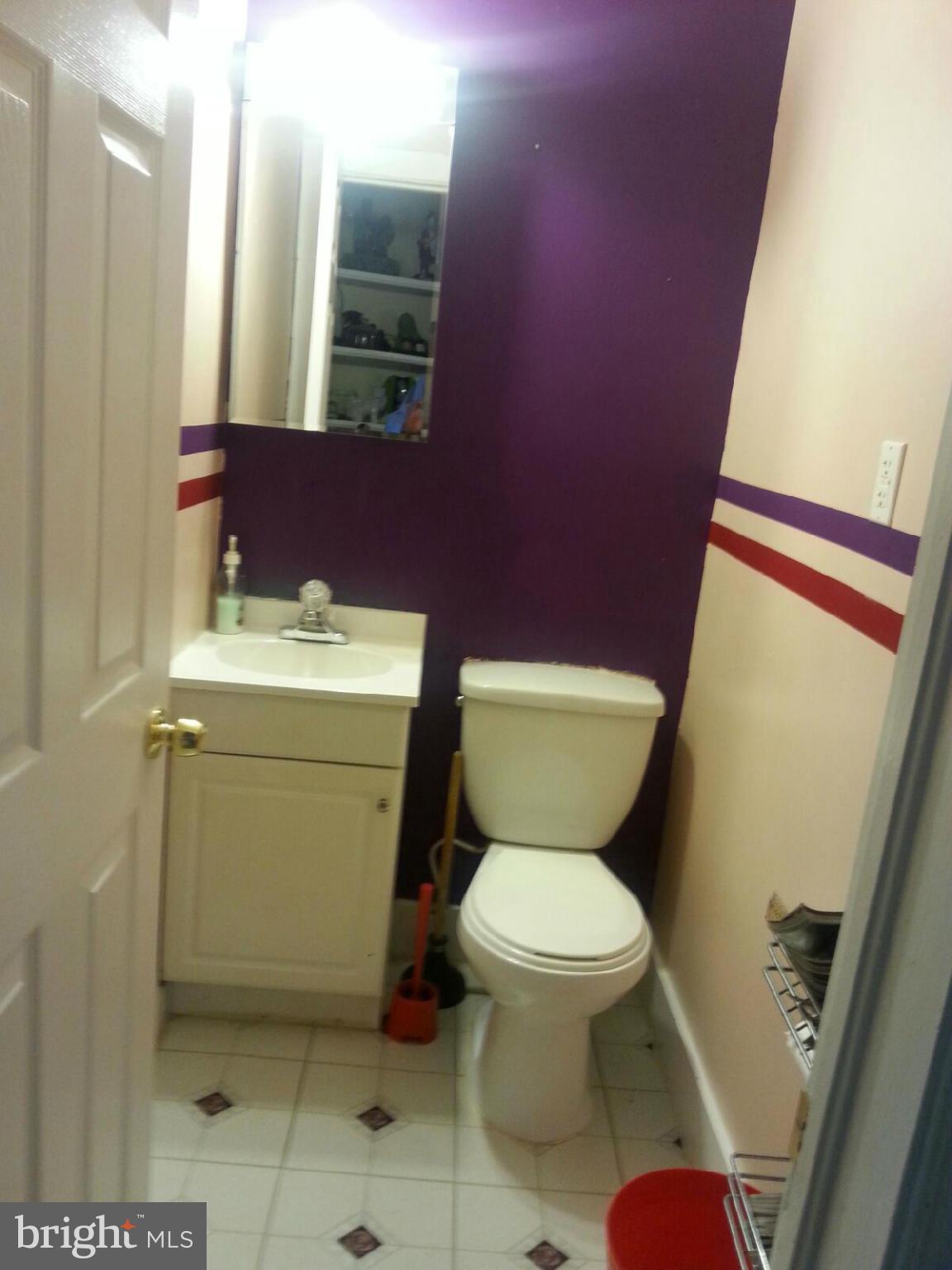 1419 Northgate Road Baltimore, MD 21218 - Photo 4 of 8 a bathroom with a toilet sink and mirror