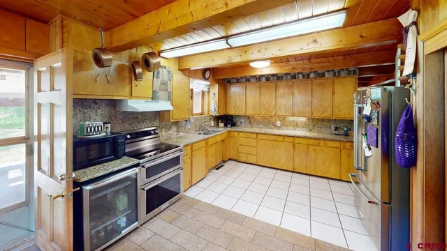 a kitchen with stainless steel appliances granite countertop sink stove and cabinets