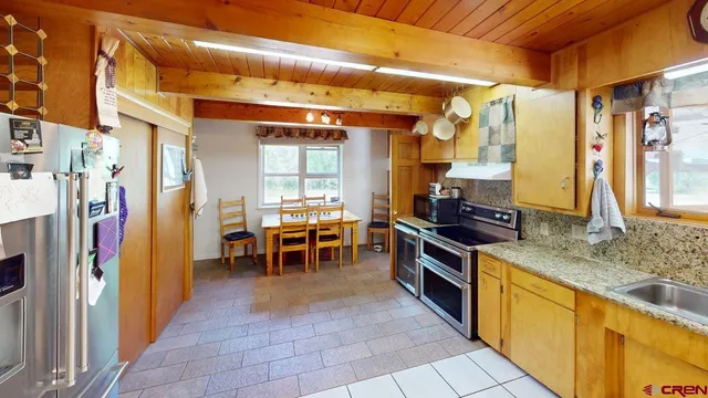 a living room with furniture a flat screen tv and gym equipment