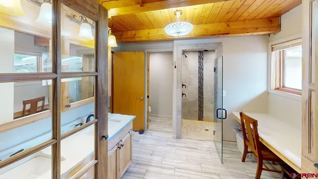 a outdoor living space with furniture a fireplace and a window