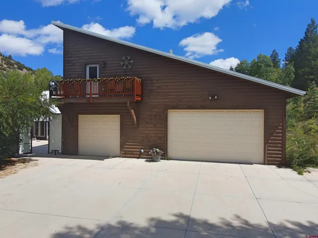 a bed sitting in a bedroom next to a lamp