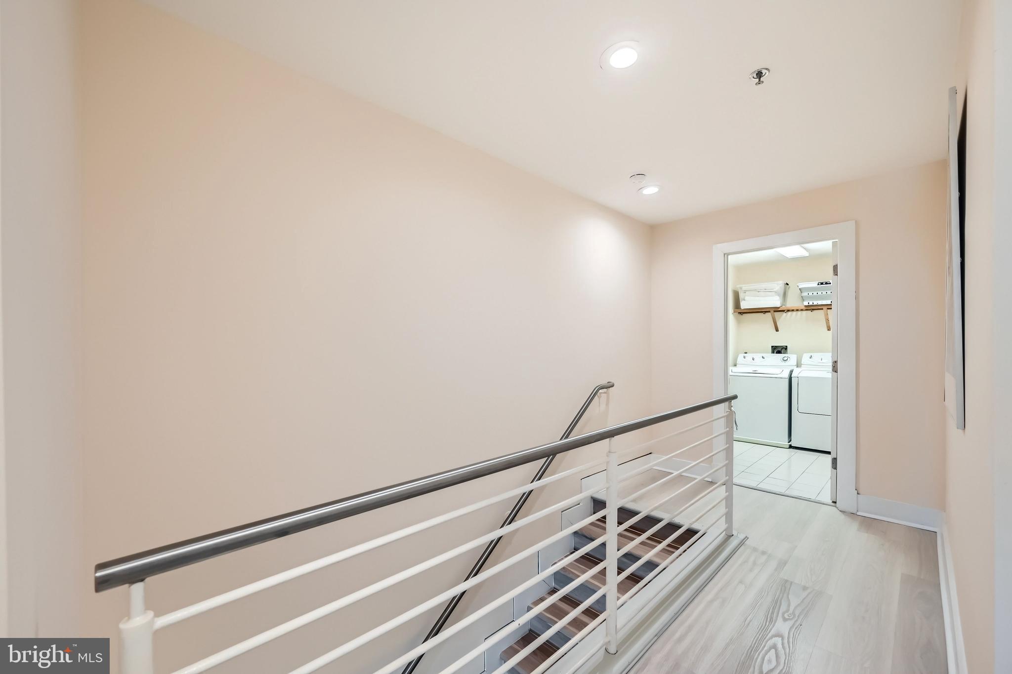 1400 Lancaster Street, Unit 303 Baltimore, MD 21231 - Photo 14 of 36 a very nice looking room with wooden floor and stairs