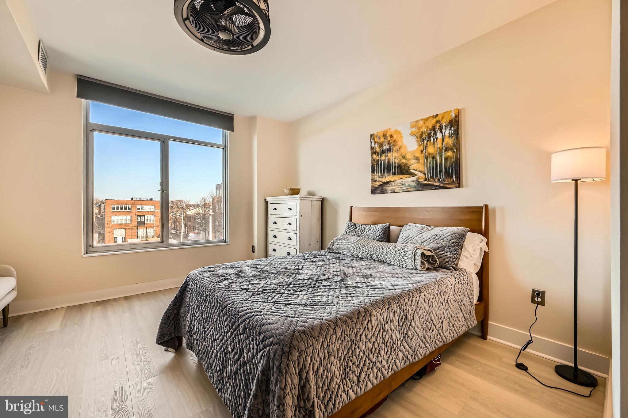 1400 Lancaster Street, Unit 303 Baltimore, MD 21231 - Photo 19 of 36 a bedroom with a bed and a window