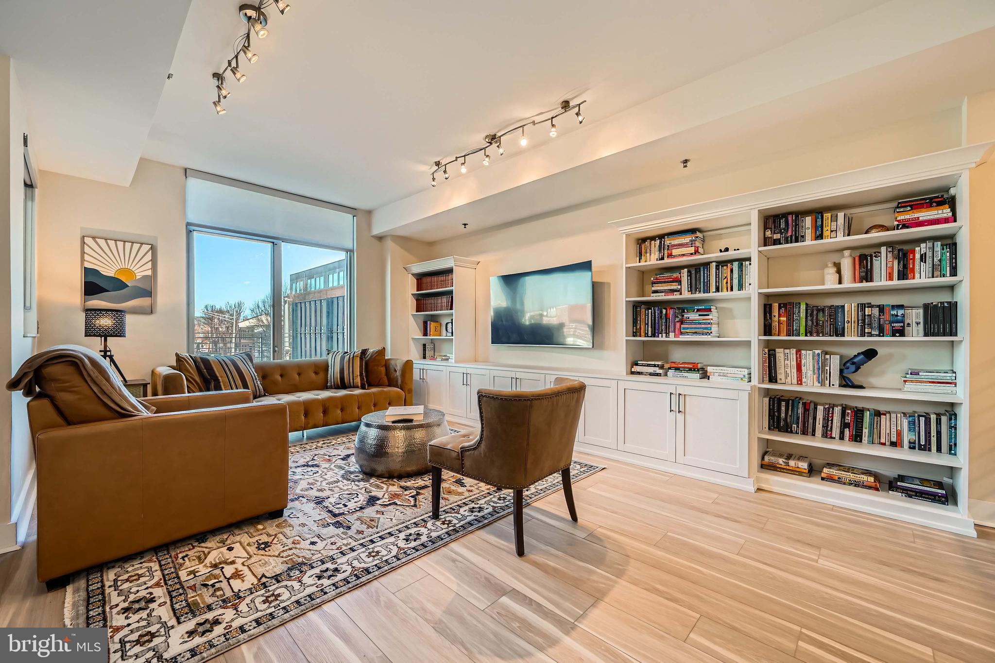 1400 Lancaster Street, Unit 303 Baltimore, MD 21231 - Photo 2 of 36 a living room with furniture and a book shelf