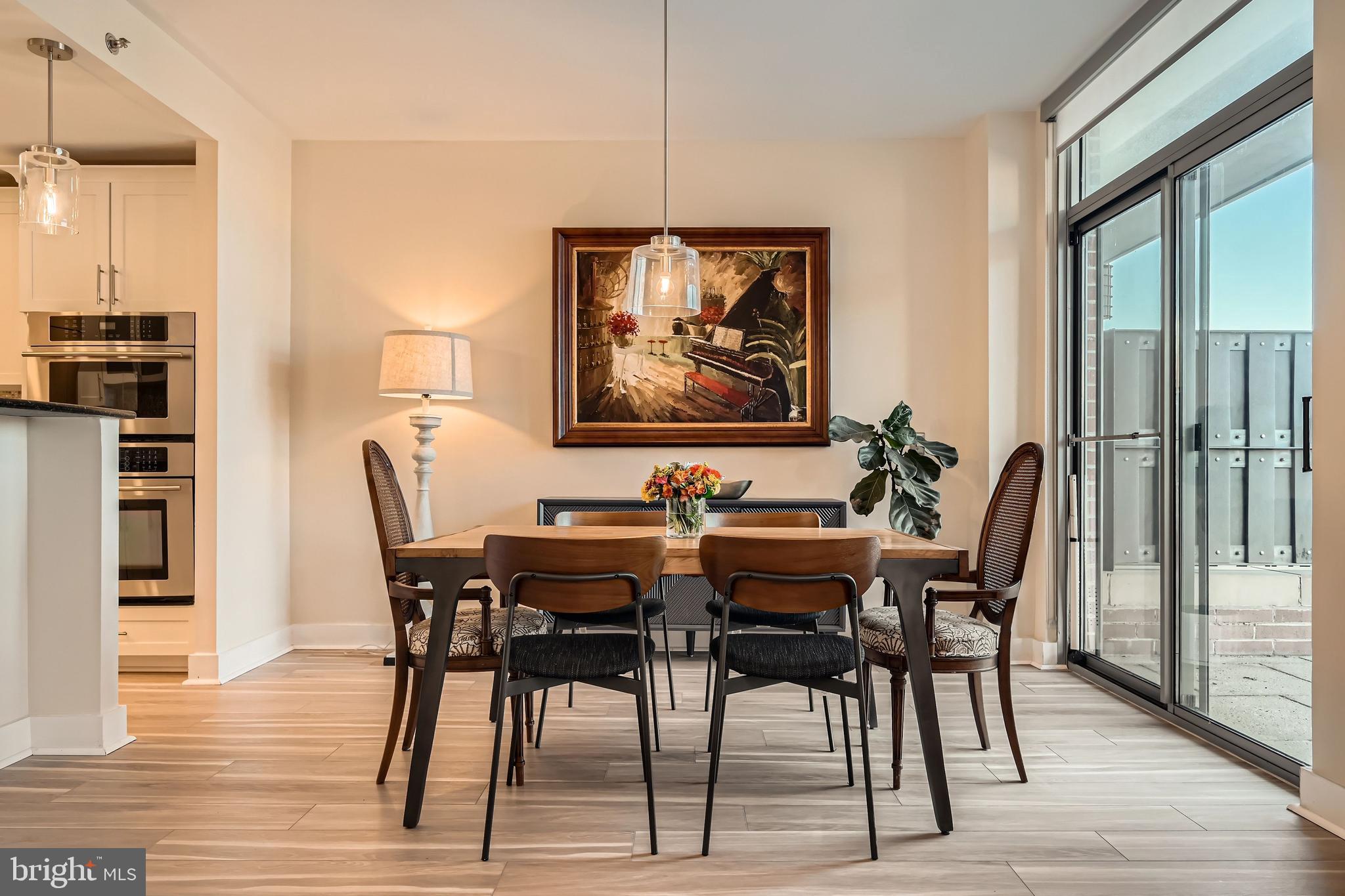 1400 Lancaster Street, Unit 303 Baltimore, MD 21231 - Photo 8 of 36 a view of a dining room with furniture and wooden floor