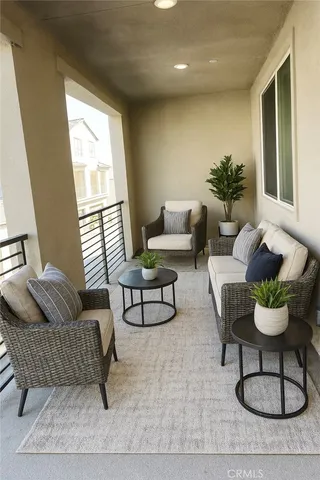 a living room with furniture and a potted plant