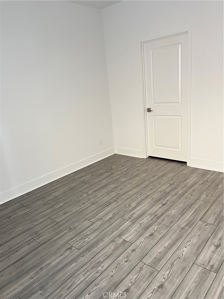 124 Sash Irvine, CA 92618 - Photo 8 of 16 a view of an empty room with wooden floor