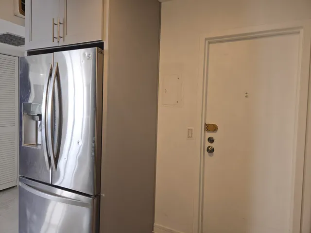 a metallic refrigerator freezer sitting in a kitchen